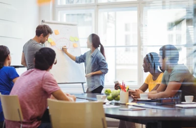 Business executives discussing with their colleagues on whiteboard