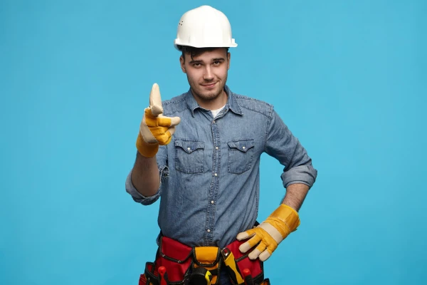Horizontal shot of handsome young maintenance service worker wea