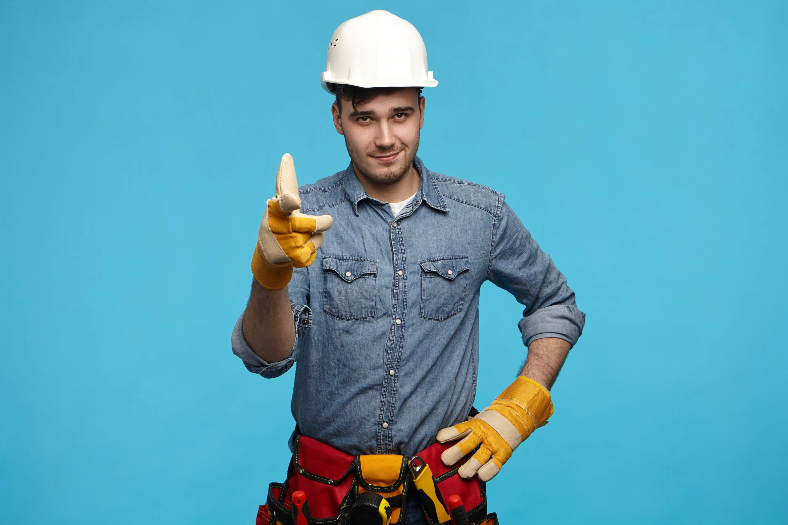 Horizontal shot of handsome young maintenance service worker wea