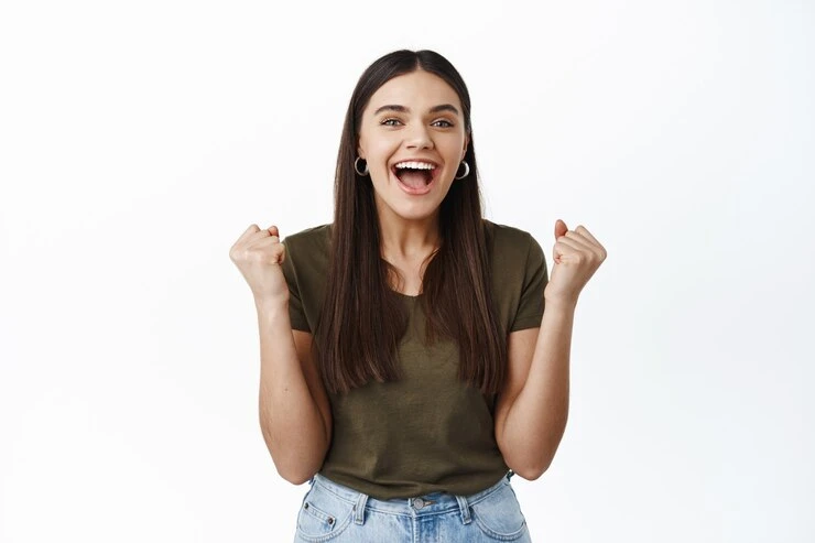 Happy young woman winning prize making fist pump smiling excited triumphing as achieve goal celebrating victory shouting amazed white wall 176420 39072