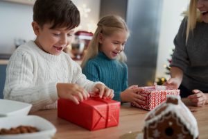 Children receiving christmas gifts from mother