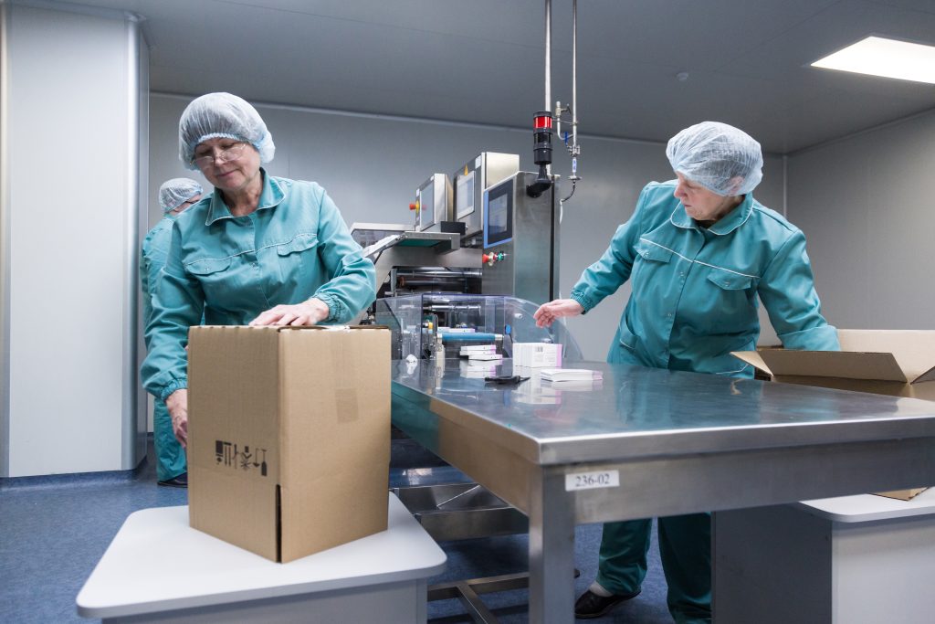 Pharmaceutical factory workers in sterile environment